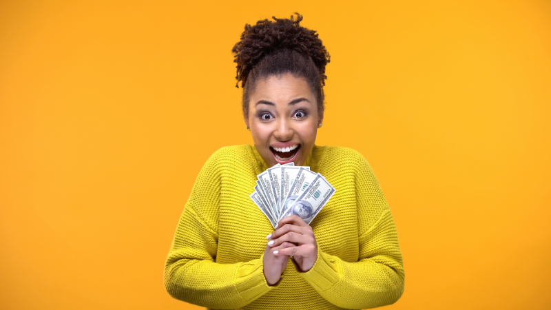 happy woman holding money